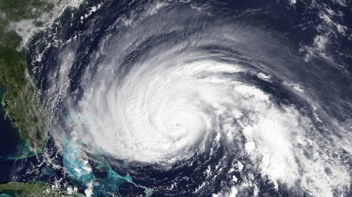 Satellite image of a powerful hurricane swirling over the Atlantic Ocean, near the eastern coast of the United States.