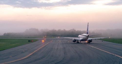 a plane sits on the runway at Richmond International Airport (RIC) on a foggy day in Virginia