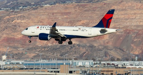 a delta airplane comes in for a landing at Salt Lake City International Airport (SLC) in Utah