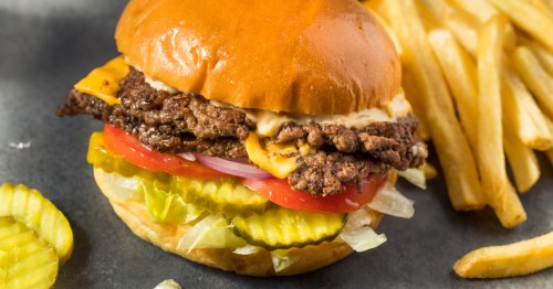 double smashburger with fresh lettuce, tomato, red onion, and pickle with a side of fries