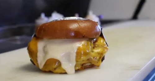 a burger dripping with cheese sits on a counter at smashley's burger bar in north charleston sc