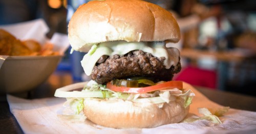 a gourmet burger sits on a plate at stella's bar and grill, bellevue nebraska